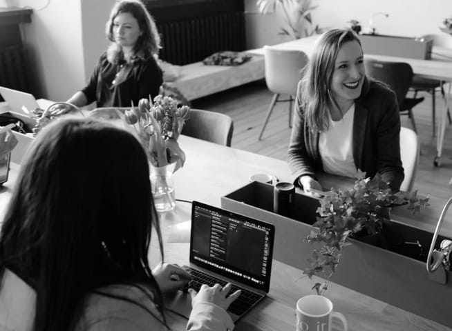 Group of people working and laughing around a table